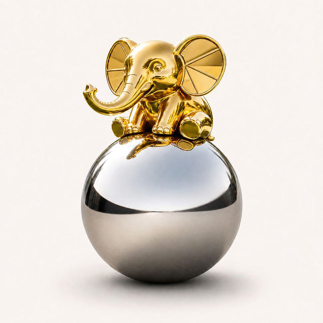Gold stainless steel elephant sculpture seated on a mirror-polished silver sphere