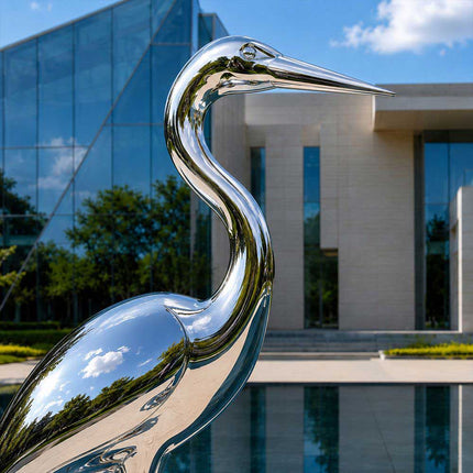 Close-up detail of a handcrafted stainless steel heron sculpture with polished surface