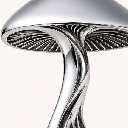 Close-up of the mushroom sculpture showing radial details beneath its rounded stainless steel cap