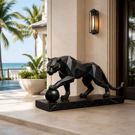 Modern stainless steel panther statue in architectural outdoor space