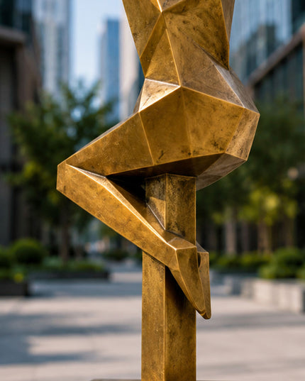 Close-up detail of bronze-tone painted stainless steel sculpture surface and geometric form