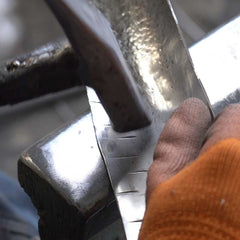 Hand forging detailed areas of stainless steel sculpture for refined structure