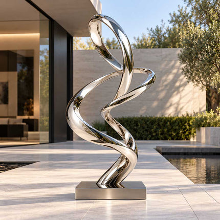 Mirror-polished stainless steel sculpture with twisting loops in a modern residential courtyard