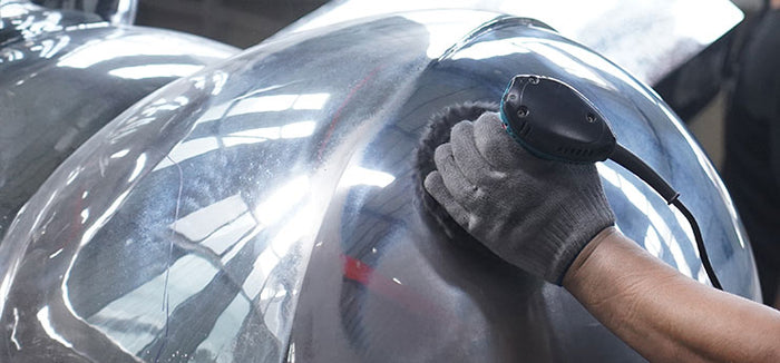 Close-up of reflective mirror finish on stainless steel sculpture surface