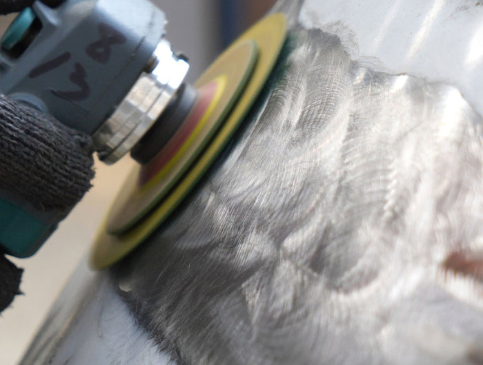 Rough grinding stainless steel sculpture to remove welding marks and refine shape