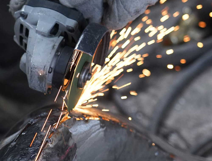 Structural trimming of stainless steel sculpture after assembly to refine final form