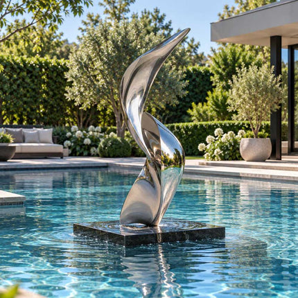 Mirror polished stainless steel sculpture installed as a focal point within a modern pool