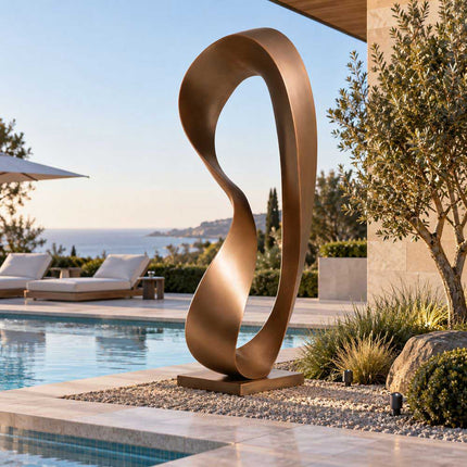 Abstract twisted bronze sculpture displayed beside a swimming pool at a contemporary coastal residence.