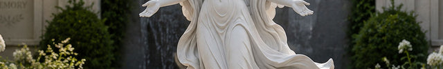 Winged angel statue carved in natural marble for religious and garden spaces