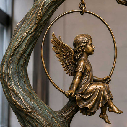 Winged figure seated on a circular swing with detailed bronze wings and drapery