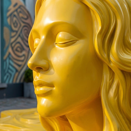 Close-up detail of yellow painted stainless steel sculpture surface and craftsmanship