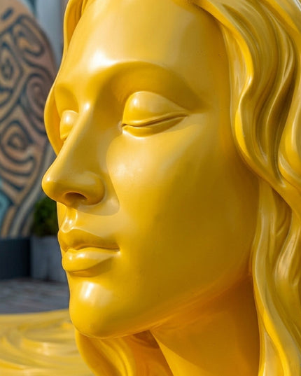 Close-up detail of yellow painted stainless steel sculpture surface and craftsmanship