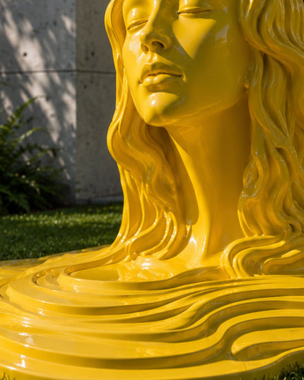 Detail view showing the high-gloss painted finish and flowing contours of stainless steel artwork